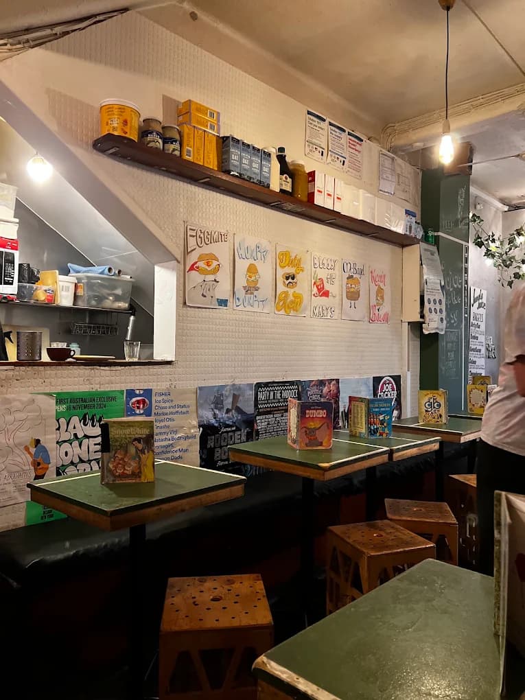 The cosy interior with green tables, stools and storybook menus